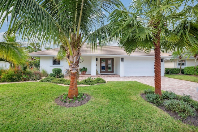 view of front facade featuring french doors and a front lawn