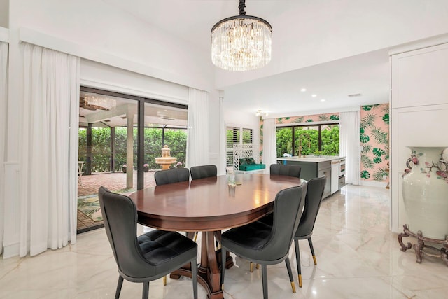 dining room with plenty of natural light and a notable chandelier