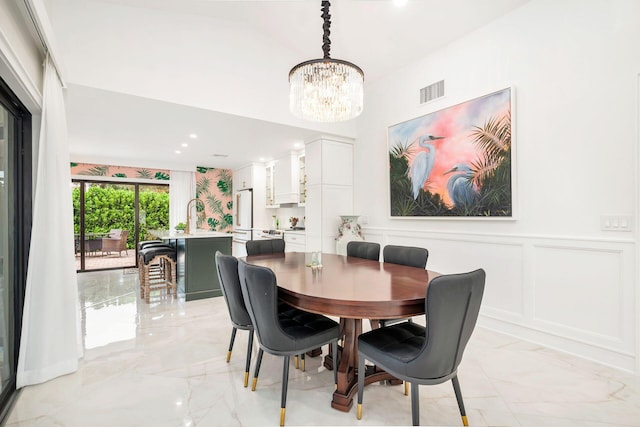 dining space featuring a notable chandelier