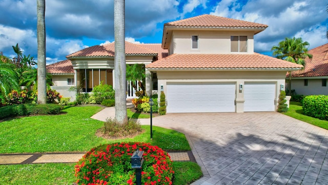 mediterranean / spanish-style house featuring a garage and a front yard