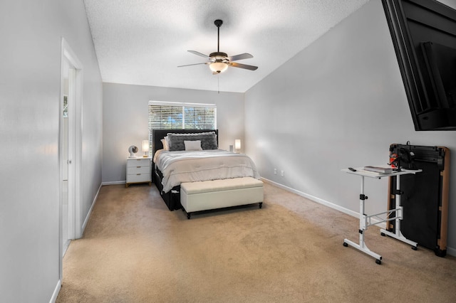 bedroom featuring a textured ceiling, light colored carpet, ceiling fan, and lofted ceiling