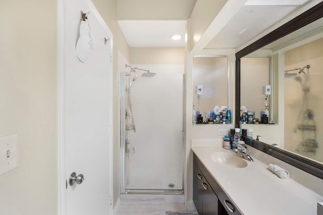 bathroom featuring vanity and an enclosed shower