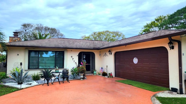 4715 Myrtle Dr, Fort Pierce, FL 34982 - single story home with roof with shingles, stucco siding, a chimney, and an attached garage
