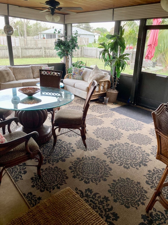 sunroom / solarium featuring ceiling fan