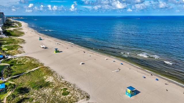 aerial view with a water view and a beach view