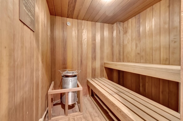 view of sauna / steam room featuring wood walls, hardwood / wood-style flooring, and wooden ceiling