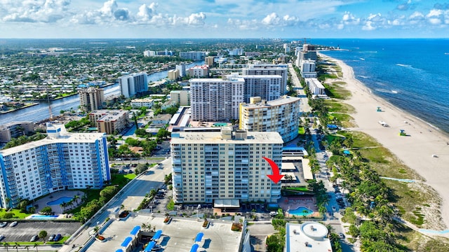 aerial view with a water view and a beach view