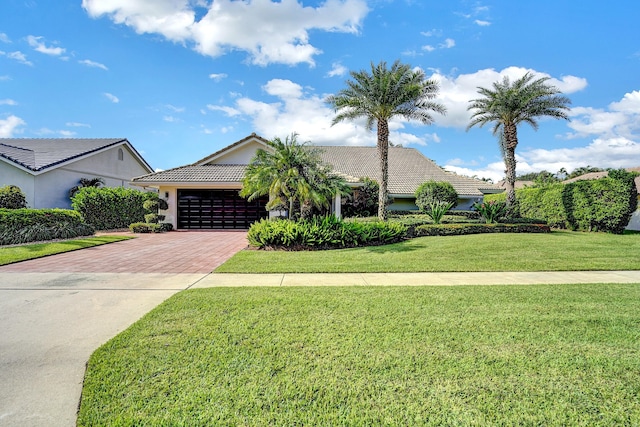 view of front of home featuring a garage and a front yard