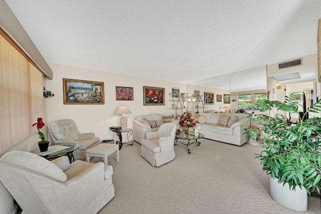 living room with light colored carpet and a textured ceiling