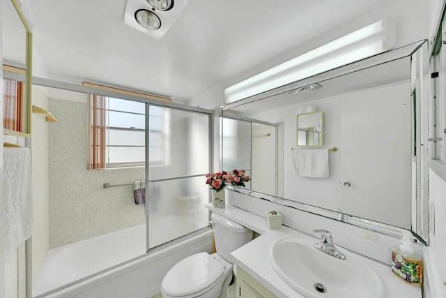 full bathroom with toilet, vanity, and combined bath / shower with glass door