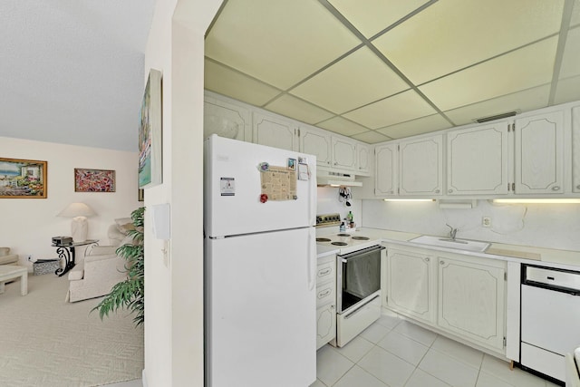 kitchen featuring white appliances, white cabinetry, a drop ceiling, and sink