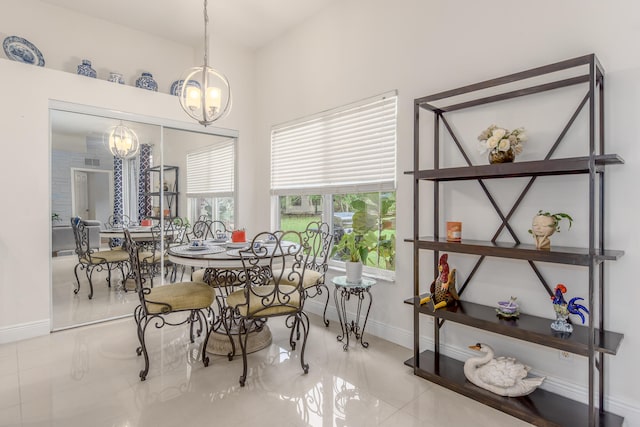 tiled dining area with a chandelier