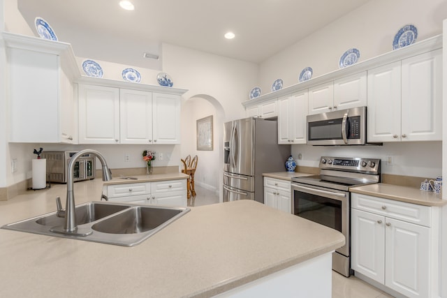 kitchen with white cabinets, sink, and stainless steel appliances