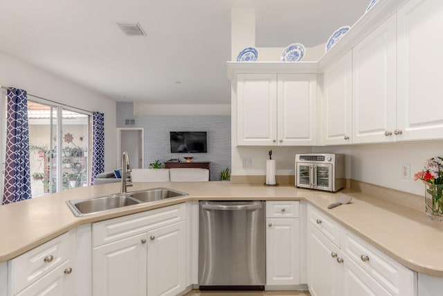 kitchen featuring dishwasher, kitchen peninsula, sink, and white cabinets