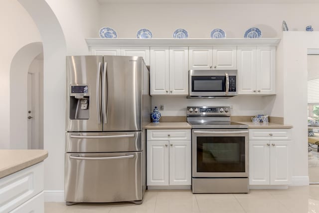 kitchen with white cabinetry, light tile patterned floors, and appliances with stainless steel finishes