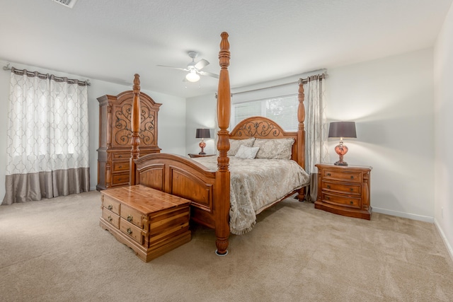 bedroom featuring light colored carpet and ceiling fan