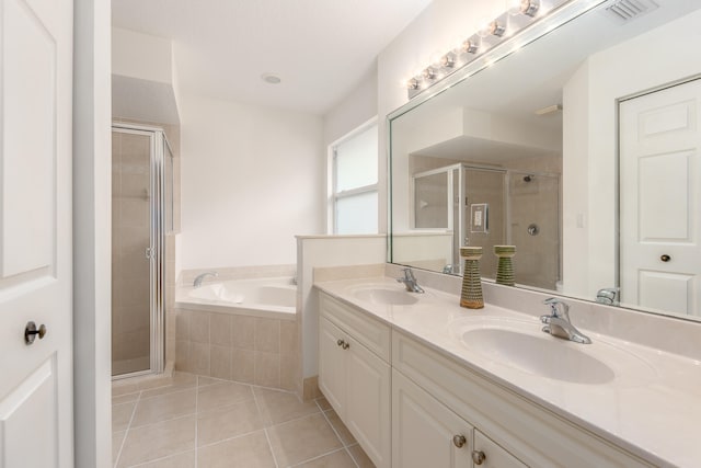 bathroom featuring vanity, plus walk in shower, and tile patterned flooring