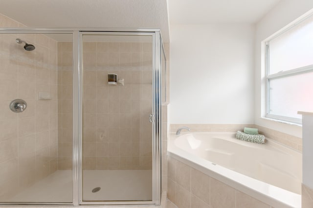 bathroom featuring separate shower and tub