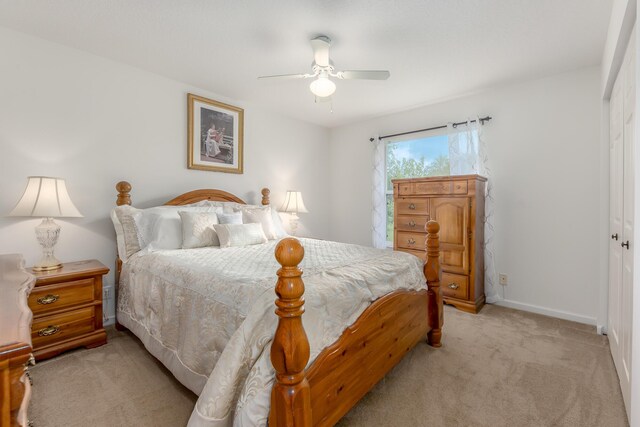 308 SW Egret Lndg, Port Saint Lucie, FL 34953 - bedroom with light colored carpet, a closet, baseboards, and a ceiling fan