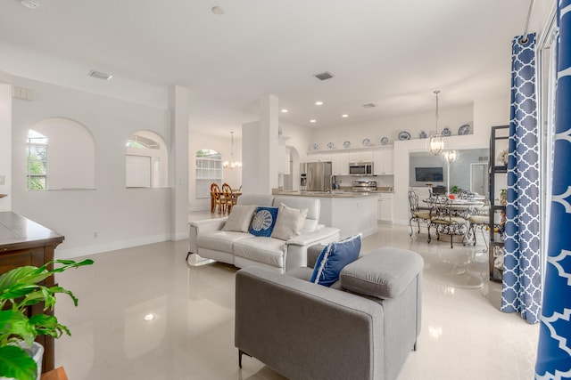 tiled living room with a chandelier