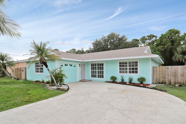 ranch-style home with a garage and a front lawn