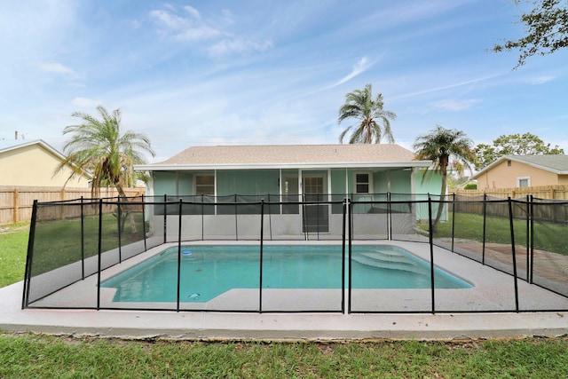 view of swimming pool with a yard