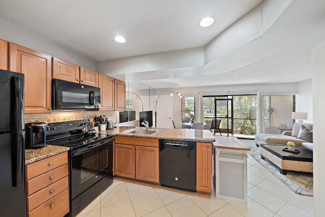 kitchen with kitchen peninsula, sink, light tile patterned floors, and black appliances