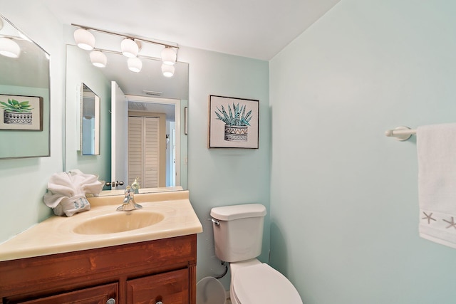 bathroom featuring vanity and toilet