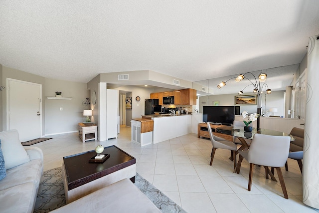 living room with light tile patterned floors and a textured ceiling