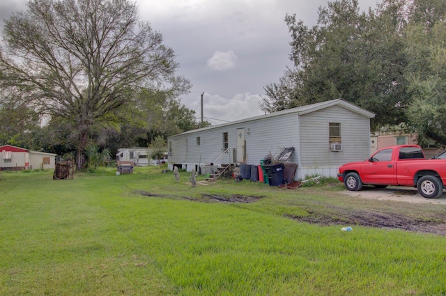 exterior space with cooling unit and a yard