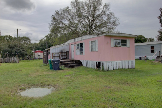 exterior space with cooling unit and a yard