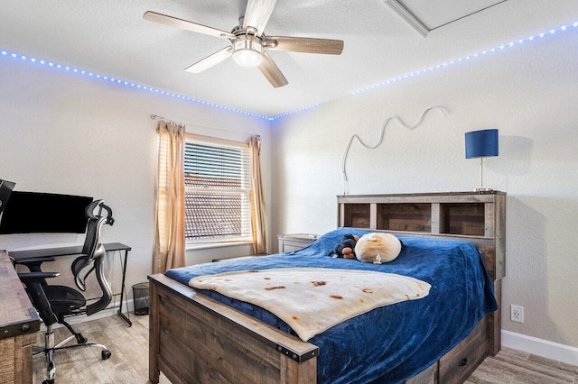 bedroom with ceiling fan and light wood-type flooring