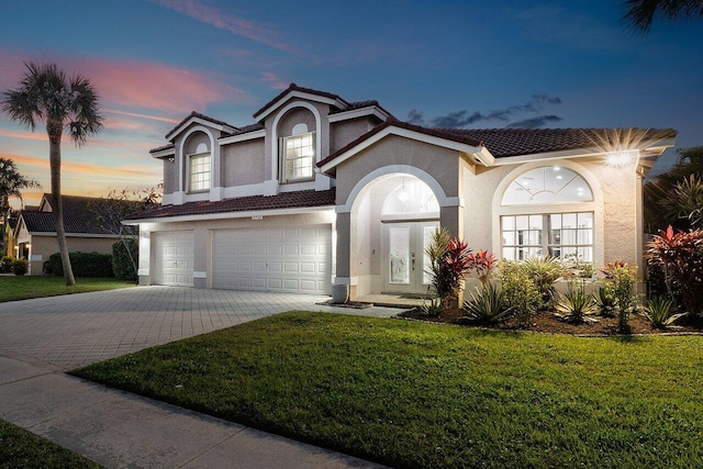 view of front of house with a lawn and a garage