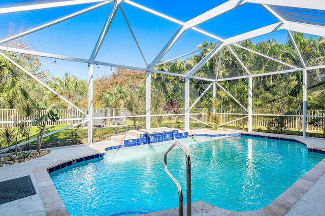 view of pool with glass enclosure