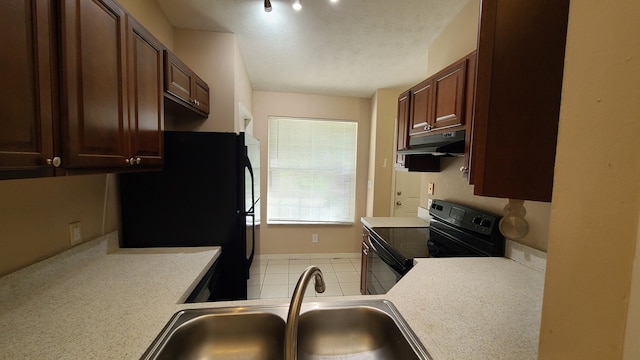 kitchen with black appliances, sink, and light tile patterned floors