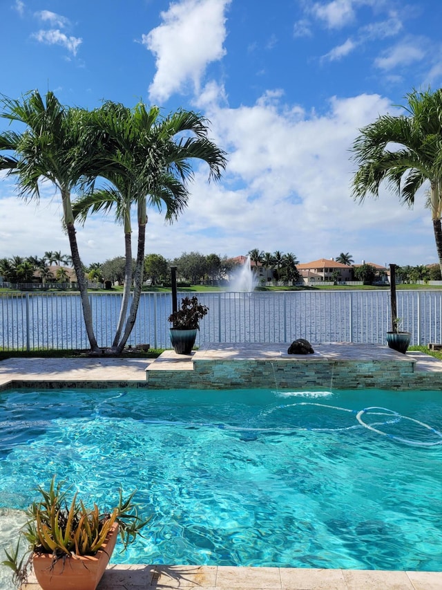 view of pool featuring a water view