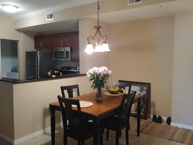 dining room with light tile patterned floors, crown molding, and an inviting chandelier