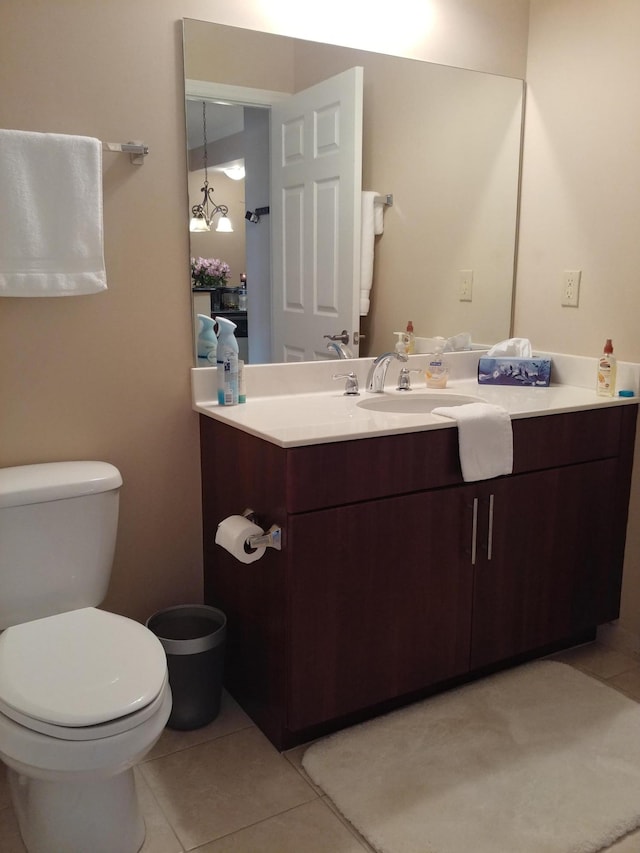 bathroom featuring toilet, vanity, and tile patterned floors