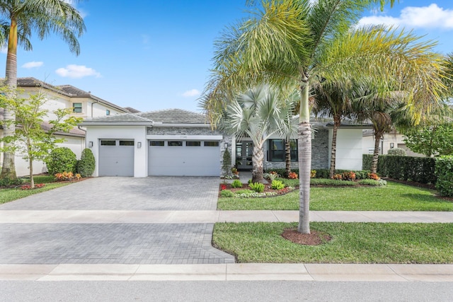 view of front of home featuring a garage and a front lawn