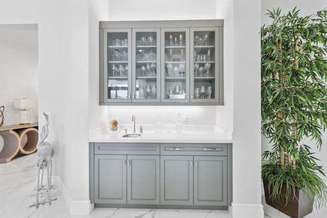 bar featuring sink and gray cabinetry