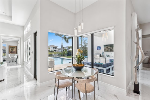 dining room featuring a towering ceiling