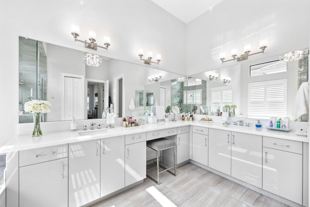 bathroom featuring walk in shower and vanity