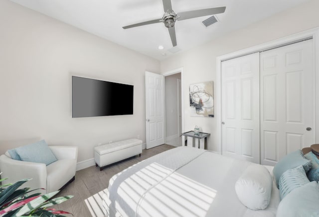 bedroom featuring a closet, ceiling fan, and light hardwood / wood-style flooring