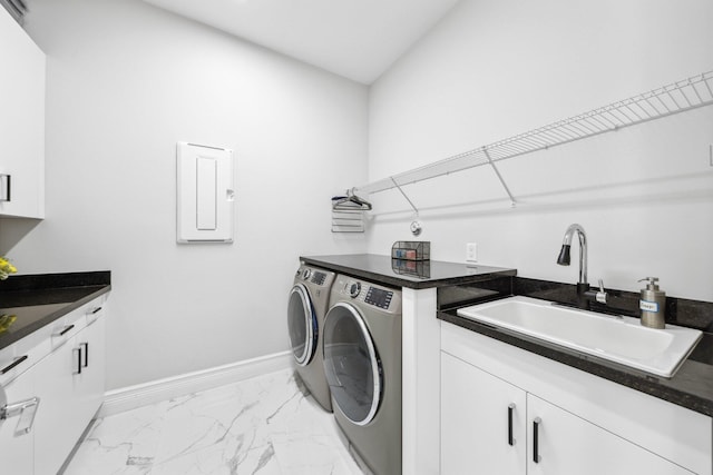 washroom featuring cabinets, washer and dryer, and sink