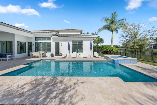 view of swimming pool featuring a patio area and an in ground hot tub