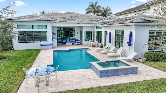 rear view of house featuring a swimming pool with hot tub, an outdoor living space, a yard, and a patio