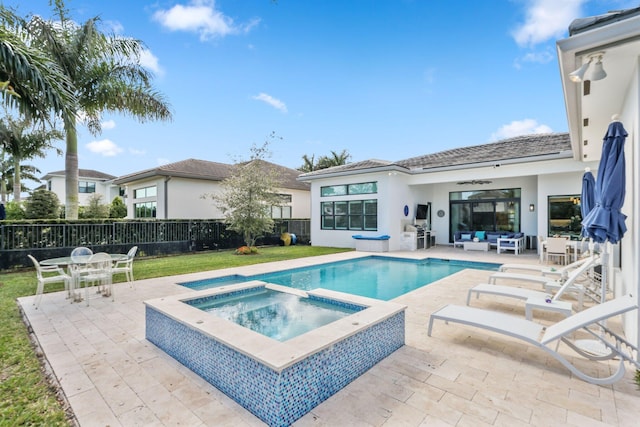 view of pool featuring an outdoor living space, a patio area, and an in ground hot tub