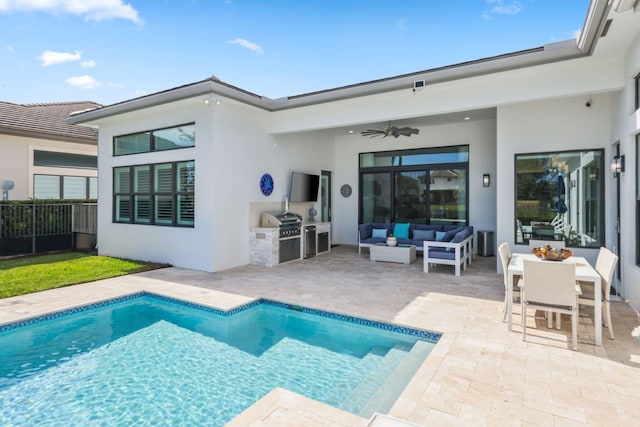 back of house featuring ceiling fan, an outdoor kitchen, an outdoor living space, and a patio