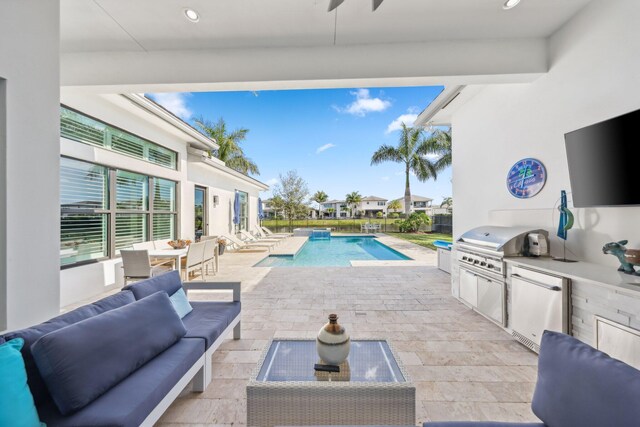 view of swimming pool with ceiling fan, area for grilling, outdoor lounge area, and a patio area