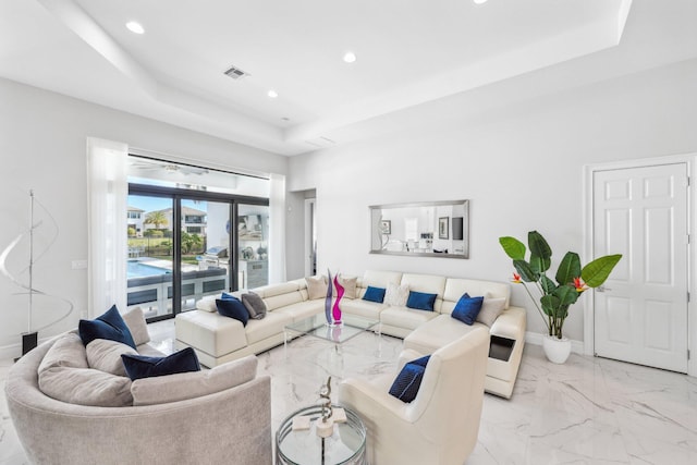 living room featuring a raised ceiling